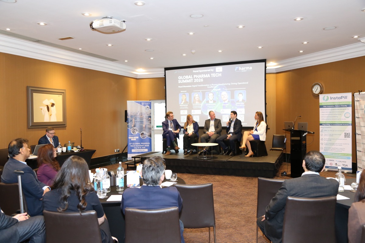 Wide view of the panel discussion at the Global Pharma Tech Summit 2026, full audience and stage visible